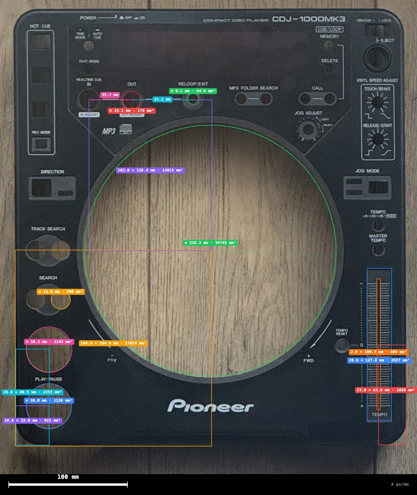 The top case of a CDJ-1000MK3, photographed from above with dozens of coloured measurement labels on its buttons, fader slot and jog opening.